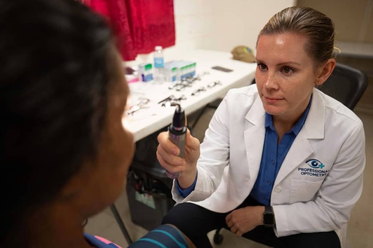 A home eye test being carried out for an older patient, with costs explained beforehand