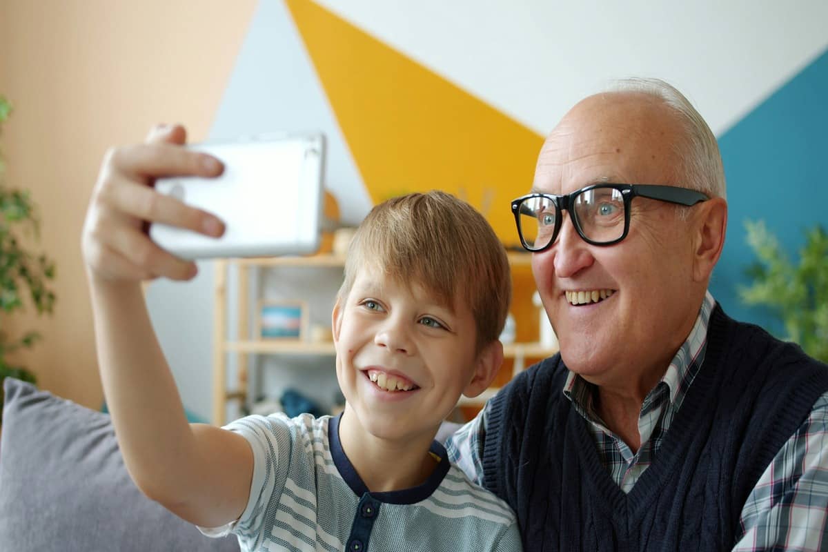An optometrist explaining free NHS home eye test eligibility to an older woman at home